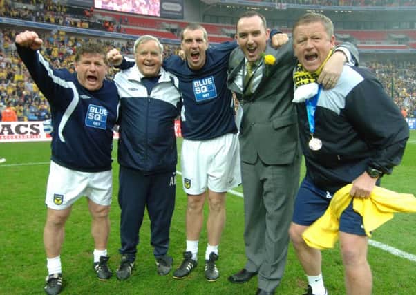 HAPPY DAY - Chris Wilder (right) and Kelvin Thomas (second from right) enjoy Oxford United's Conference play-off final success at Wembley in May, 2010