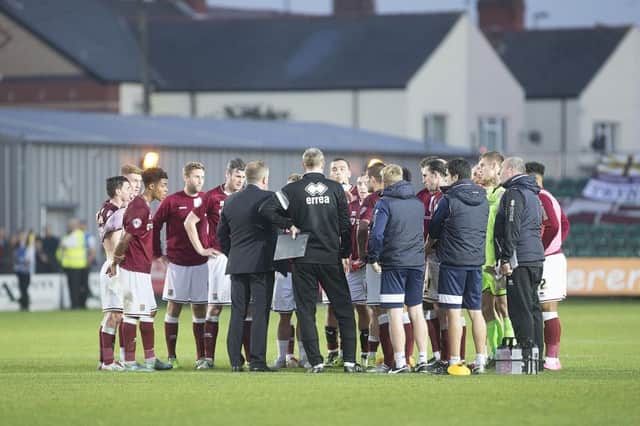 Chris Wilder and his staff join the players for an extended post-match huddle on the pitch at Rodney Parade. Pictures by Kirsty Edmonds
