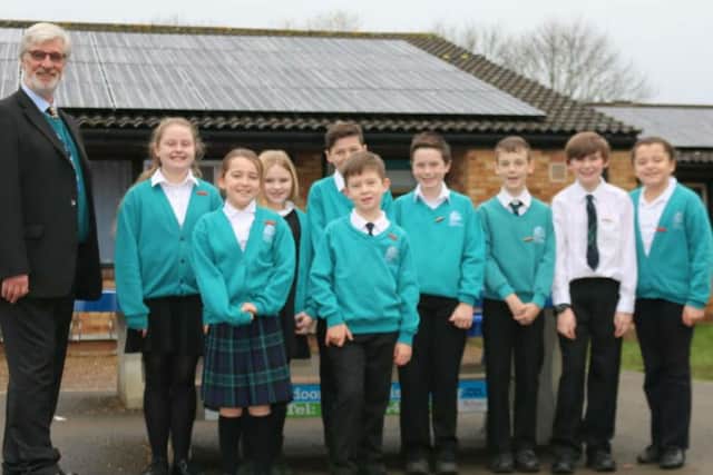 Martin Blake, school business manager, and students from Nicholas Hawksmoor School council