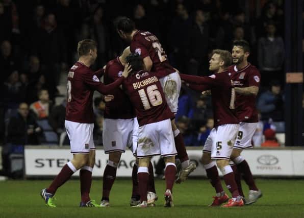 Ricky Holmes is mobbed by team-mates after his sensational winner (pictures by Liam Smith)