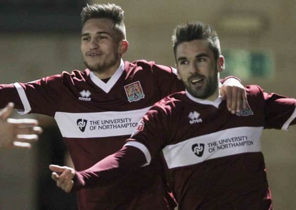 WINNING FEELING - Ricky Holmes celebrates with Lawson D'Ath after scoring the only goal of the game in the Cobblers' win over Portsmouth in March