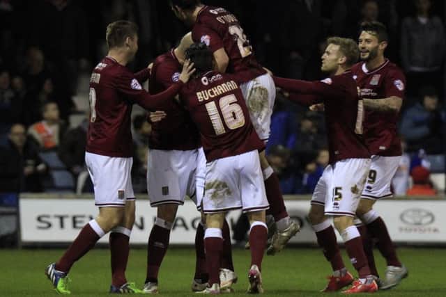 The Cobblers players celebrate Ricky Holmes' goal at Luton Town