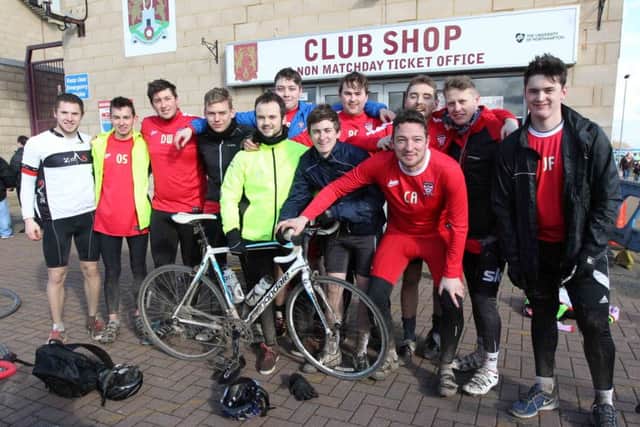 The cyclists arriving at Sixfields Stadium after last year's charity bike ride in memory of David Henderson