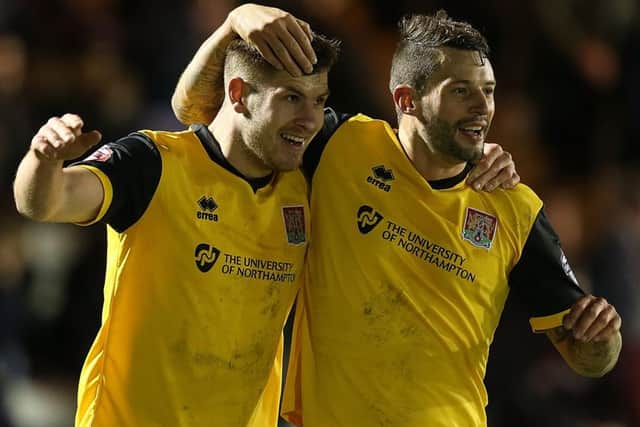 GREAT START - James Collins (left) celebrates with Marc Richards after scoring his first goal for the Cobblers at Plymouth on Tuesday (Picture: Pete Norton)
