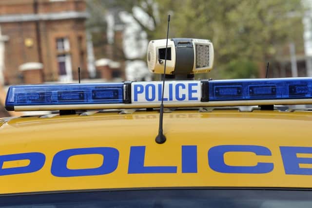 A 15-year-old boy was punched by a man who also kicked his football over a fence