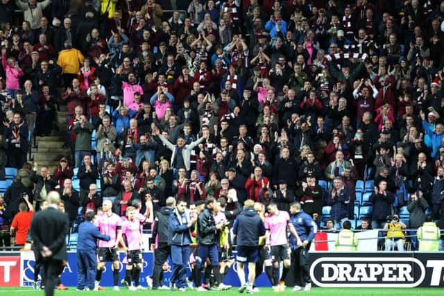 The Cobblers fans and players celebrate the FA Cup first-round win at Coventry City