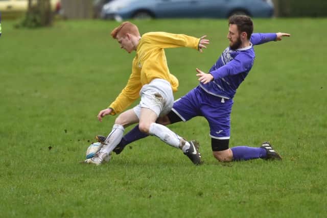 SLIDING IN - action from Standens Barn's 3-0 Sunday Combination League Premier Division win over Midshire Electrical (Pictures: Dave Ikin)