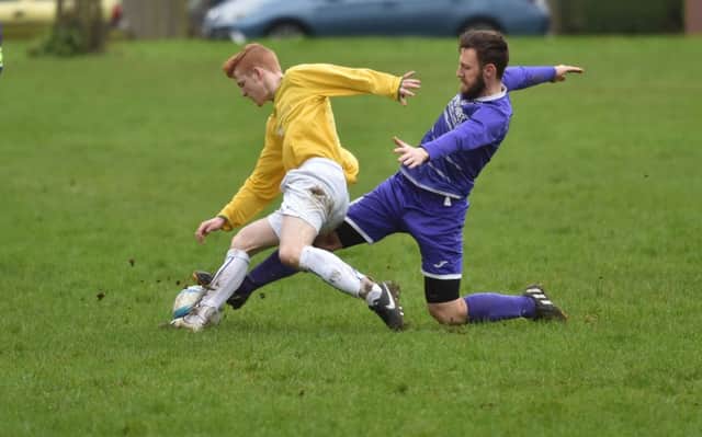 SLIDING IN - action from Standens Barn's 3-0 Sunday Combination League Premier Division win over Midshire Electrical (Pictures: Dave Ikin)