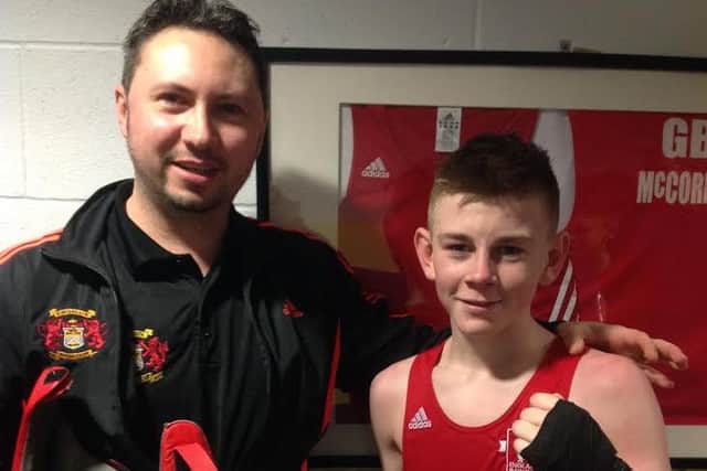 Kings Heath ABC fighter Eithan James poses with coach James Conway after winning an international bout