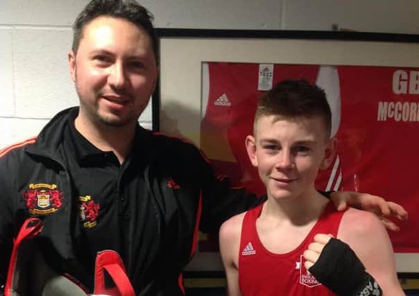 Kings Heath ABC fighter Eithan James poses with coach James Conway after winning an international bout