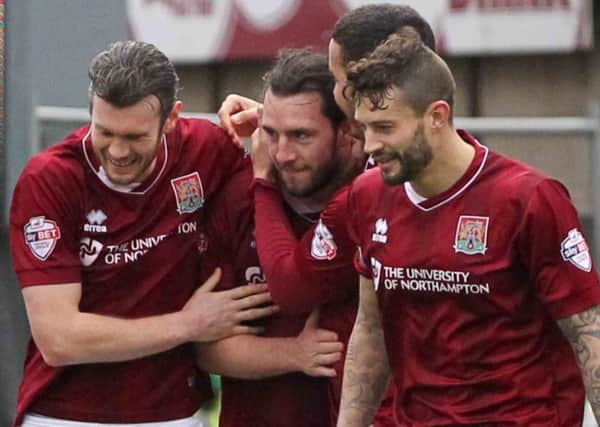 DEADLOCK BROKEN - John-Joe O'Toole is mobbed by team-mates after scoring the Cobblers' first goal against York City (Pictures: Sharon Lucey)
