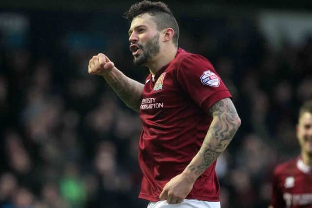 Skipper Marc Richards, pictured here celebrating against York at Sixfields earlier this month, faces four weeks out