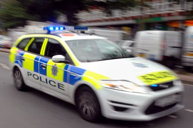 A man was knocked to the ground and robbed of his mobile phone by three men after being verbally abused in Kettering.