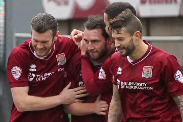PLENTY OF EXPERIENCE - Cobblers boss Chris Wilder says the squad, captained by Marc Richards (above, right) are policing themselves
