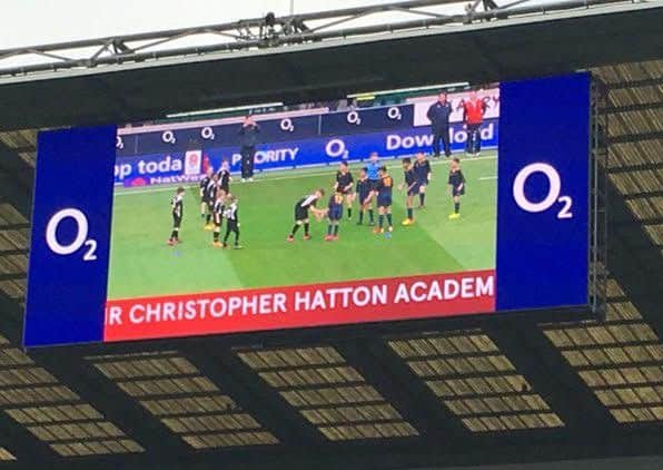 The school team on the big screen at Twickenham