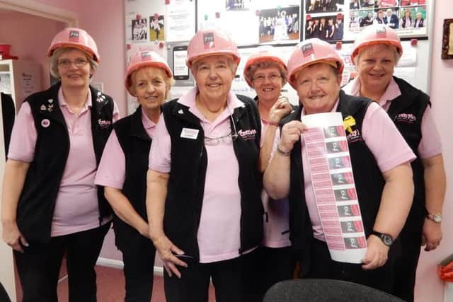 Some of the Crazy Hats team wearing the pink hard hats