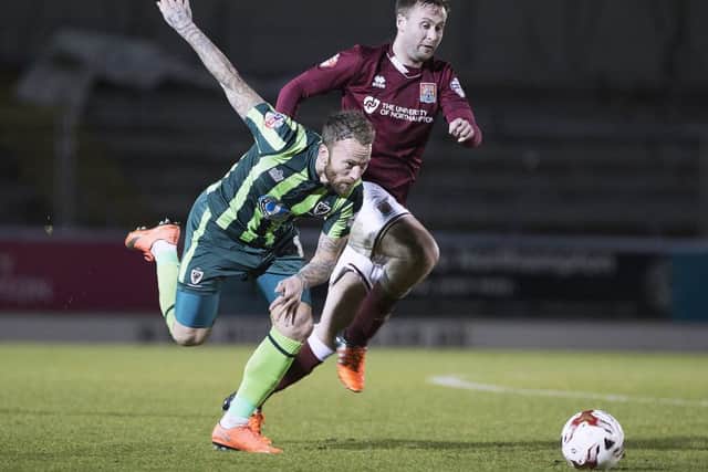 STILL GOING STRONG - Joel Byrom in action for the Cobblers in Tuesday's draw with AFC Wimbledon (Picture: Kirsty Edmonds)