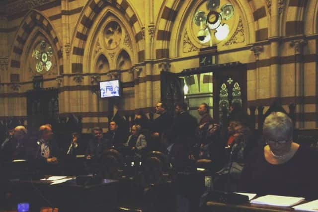 Members of the public walk out of the Guildhall last night after a vote to house 50 Syrian refugee families in the town was defeated.