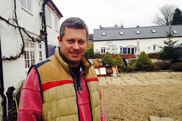 Dr Matthew Wyse at his flood damaged home in Yelvertoft. The air medic took to his canoe to rescue stranded villagers on Wednesday.