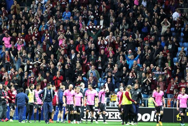 IN IT TOGETHER - the Cobblers players and supporters enjoy the FA Cup win at Coventry City in November, when the future of the club was in serious doubt