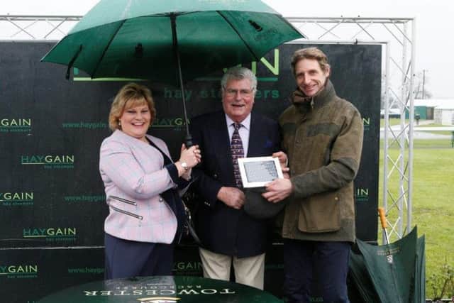 TRAINER Tom Lacey (right) is pictured in the winner's enclosure at Towcester's last meeting with regular course supporters Maurice Folley and his daughter Michelle after the victory of Kelsey which could follow up at the Northants track on Thursday (Picture courtesy of www.gjmultimedia.co.uk)
