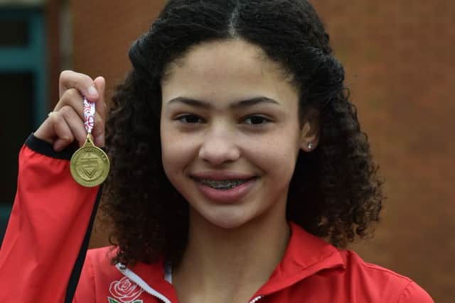 Emily Williams shows off the gold medal she won for winning the English Schools cross-country championship