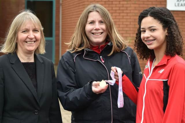 Emily Williams is pictured with Northampton School for Girls head teacher Julia Harley (left) and PE teacher Louise Sharp
