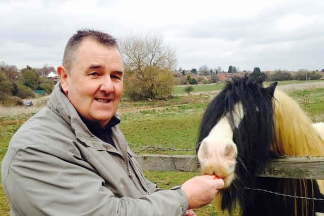 Dog walker Richard Lane, pictured with the horse he rescued fom the banks of the River Nene a fortnight ago.