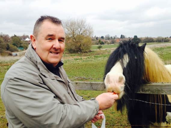 Dog walker Richard Lane, pictured with the horse he rescued fom the banks of the River Nene a fortnight ago.
