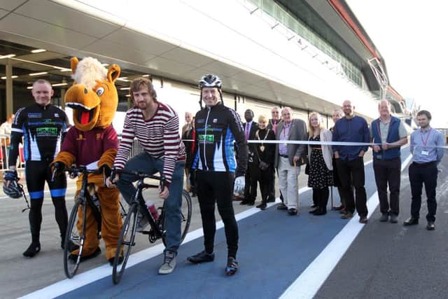 The NorPIP charity bike ride at Silverstone circuit. Saints player Tom Wood just before cutting the ribbon to start the cycle. NNL-160326-004752009