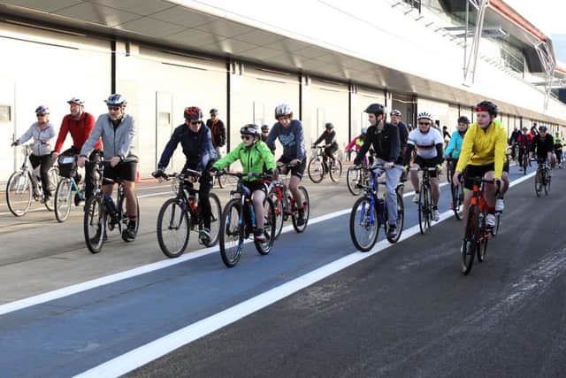 The NorPIP charity bike ride at Silverstone circuit. Saints player Tom Wood just before cutting the ribbon to start the cycle. NNL-160326-004803009
