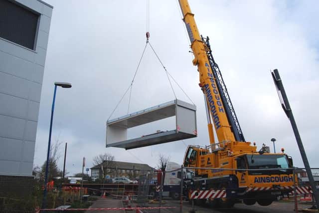 Part of the new building being lifted into place
