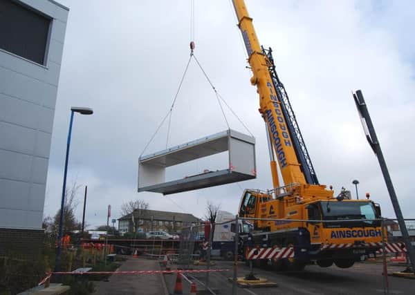 Part of the new building being lifted into place