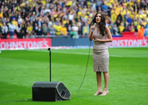 Faryl Smith singing the national anthem before the game