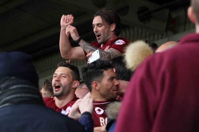 PARTY TIME: Ricky Holmes gets into the swing of things as Cobblers celebrate their promotion (pictures by Sharon Lucey)