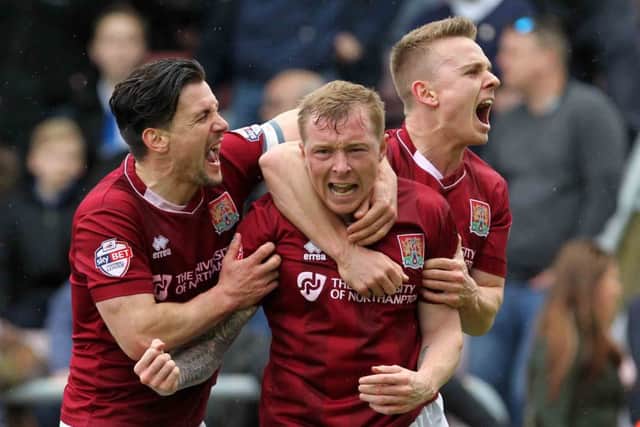 Nicky Adams, David Buchanan and Sam Hoskins celebrate after Cobblers go ahead against Bristol Rovers (pictures by Sharon Lucey)