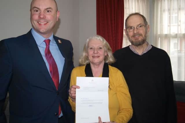 Councillor Matthew Golby with Steve and Jenny Harris and their letter of commendation from Kensington Palace.