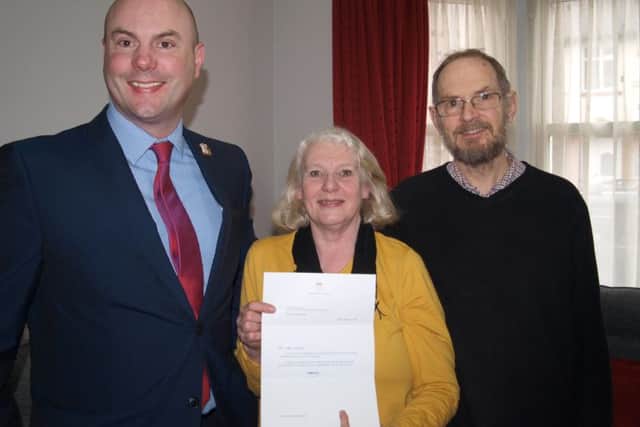 Cllr Matthew Golby with Steve and Jenny Harris and their letter of commendation from Kensington Palace.