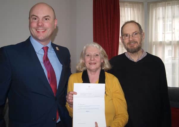 Cllr Matthew Golby with Steve and Jenny Harris and their letter of commendation from Kensington Palace.