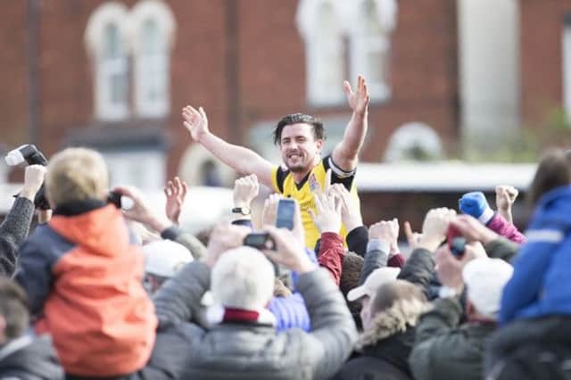David Buchanan held aloft by fans after the final whistle