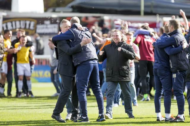 WE'VE DONE IT! - Chris Wilder embraces assistant manager Alan Knill after Saturday's draw at Exeter. Now the Cobblers boss is targeting more records (Picture: Kirsty Edmonds)