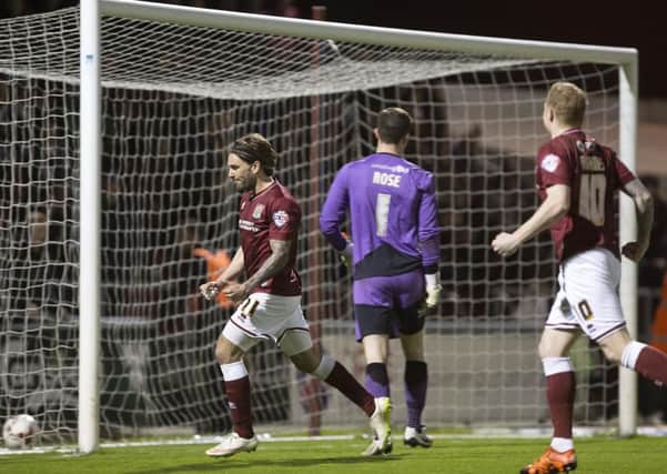 DEADLOCK BROKEN - Ricky Holmes celebrates after firing home the penalty that saw the Cobblers take the lead against Crawley (Pictures: Kirsty Edmonds)