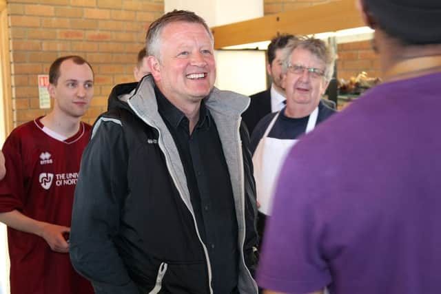 Northampton Town Football Club Manager Chris Wildervisiting Barker Shoes in Earls Barton to receive a pair of handmade shoes for taking the Cobblers into League 1