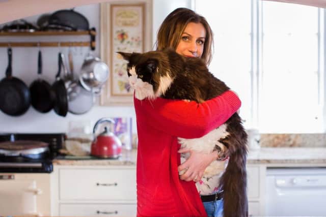 Ruth Adams, 51, from Northamptonshire, with her cat Titus, aged 9. Picture: Holly Cato