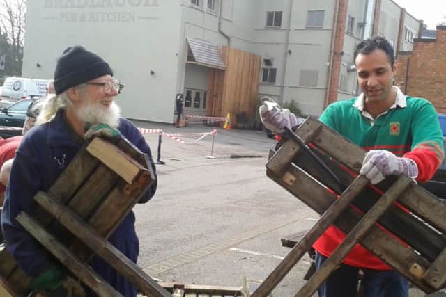 Secretary of Men's Shed Northampton, Keith Westhead, and treasurer Har Samrai, salvage wood from the Charles Bradlaugh pub to make benches back at the shed.