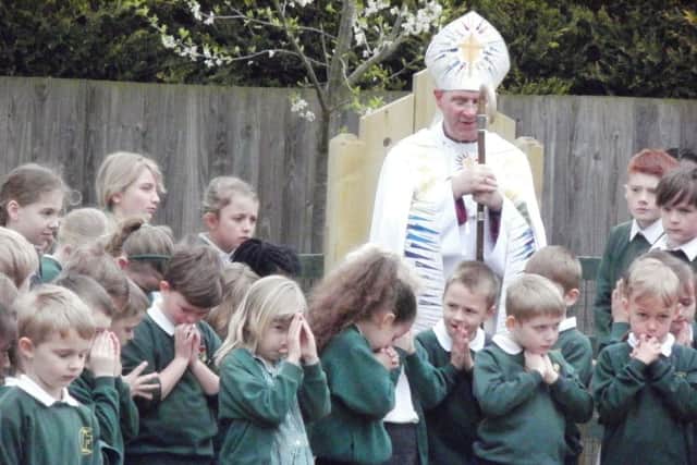 Right Reverend John Holbrook , Bishop of Brixworth leads the pupils in prayer in the new garden