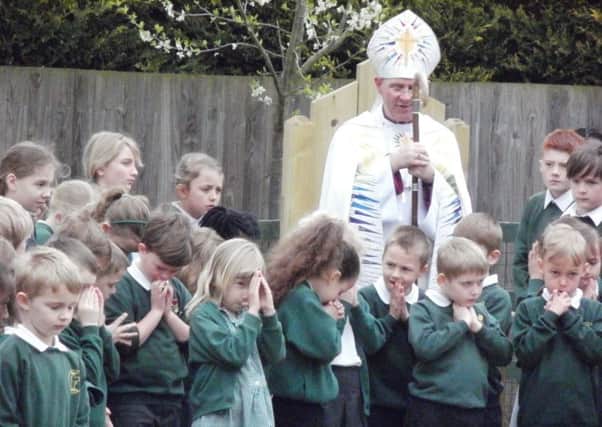 Right Reverend John Holbrook , Bishop of Brixworth leads the pupils in prayer in the new garden