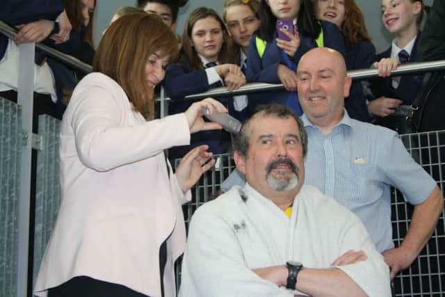 Northampton Academy maths teacher Simon White had his head shaved in front of pupils and staff to raise money for the Leukaemia Foundation