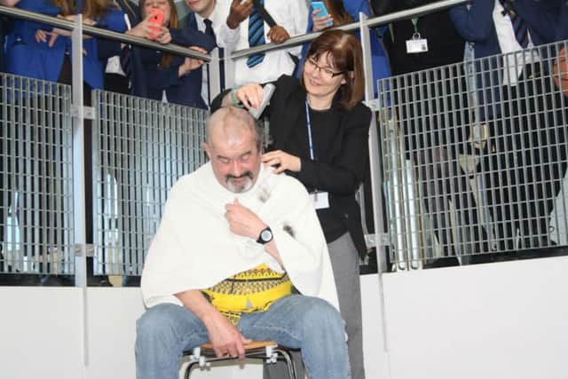 Northampton Academy maths teacher Simon White had his head shaved in front of pupils and staff to raise money for the Leukaemia Foundation