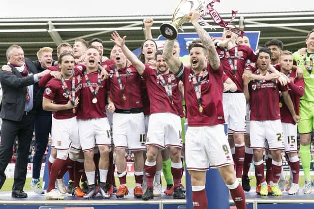 PRIZE GUY - Cobblers skipper Marc Richards lifts the Sky Bet League Two trophy aloft (Pictures: Kirsty Edmonds)